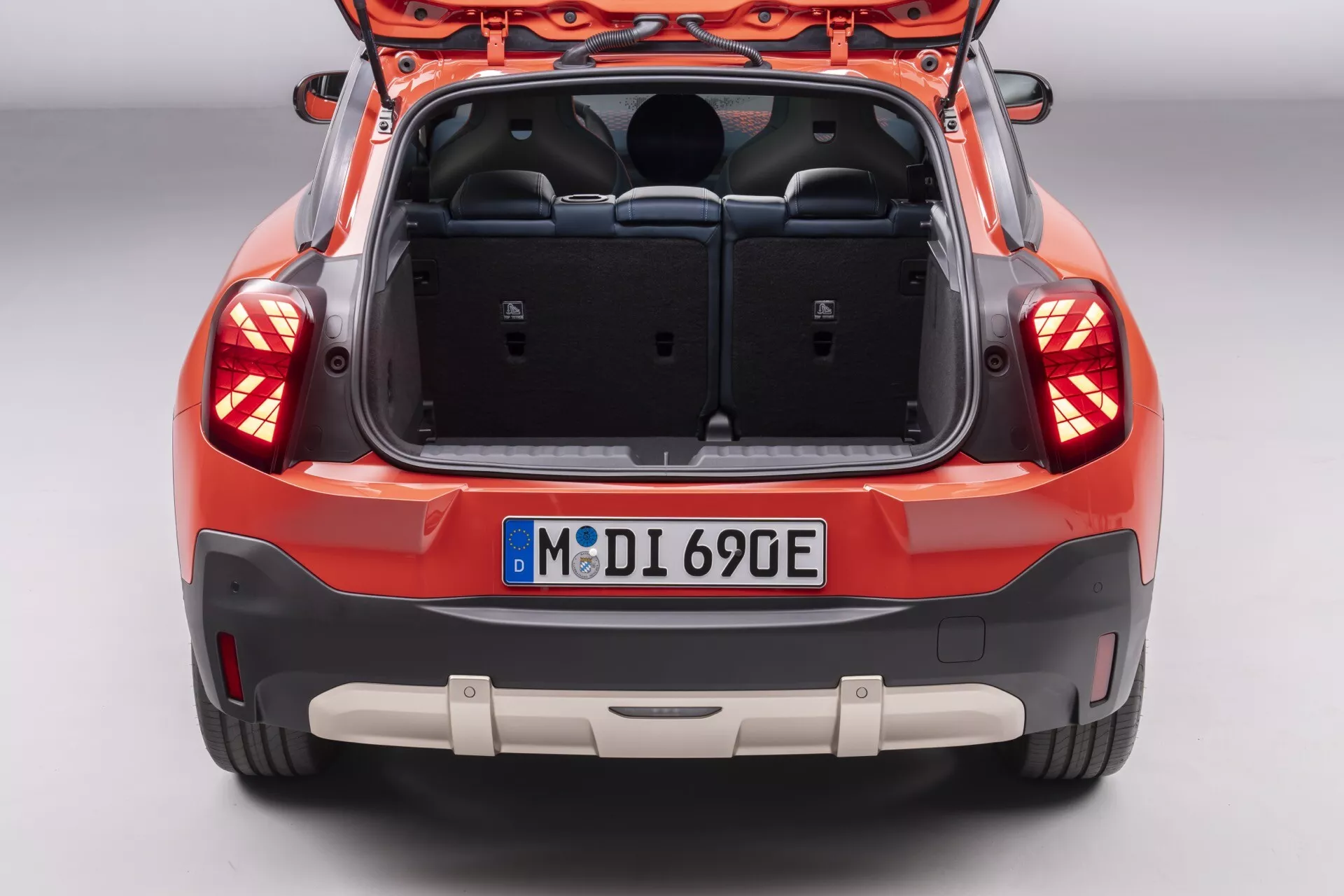 2024 Mini Aceman (J05) rear view showcasing trunk space, sleek wrap-around tail lights, and modern hatchback design without visible branding, indicating potential technology features like rear collision sensors