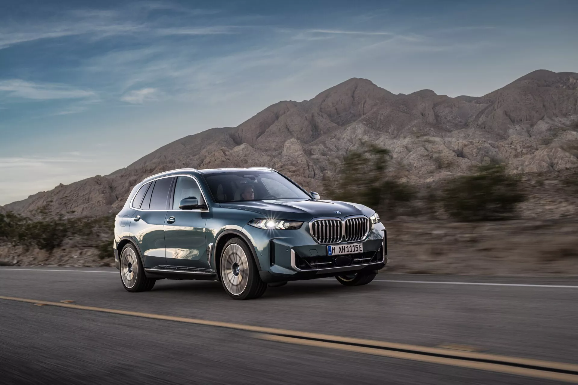 2023 BMW X5 (G05-F95 Facelift) modern luxury SUV in motion from a three-quarter front view highlighting dynamic design, large kidney-shaped grille, sleek LED headlights, multi-spoke alloy wheels, and smooth silhouette with metallic paint