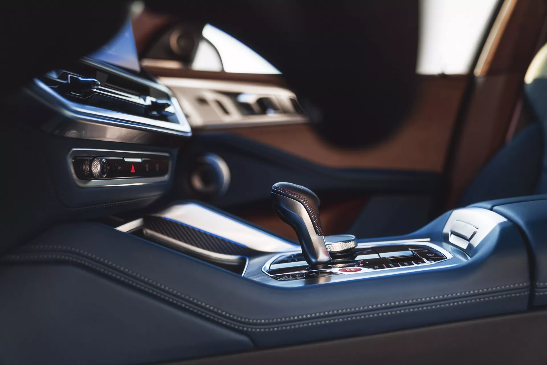 2023 BMW XM (G09) interior view focusing on the center console and automatic gear shift lever with advanced technology features and luxurious trim