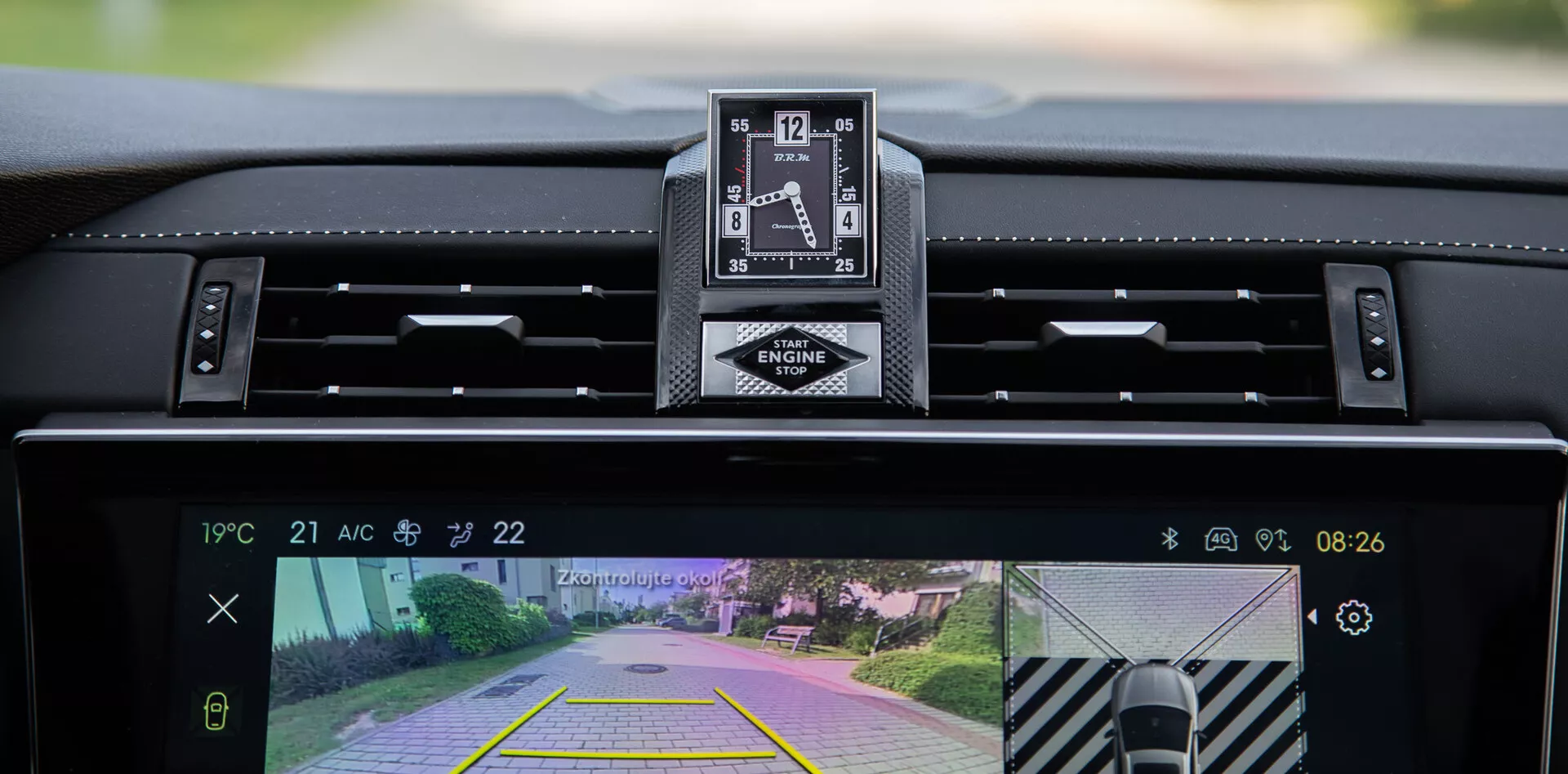 Interior view of the 2022 DS Automobiles DS-7 showcasing the dashboard, luxury analog clock, and central infotainment system display with rearview camera and parking assist feature