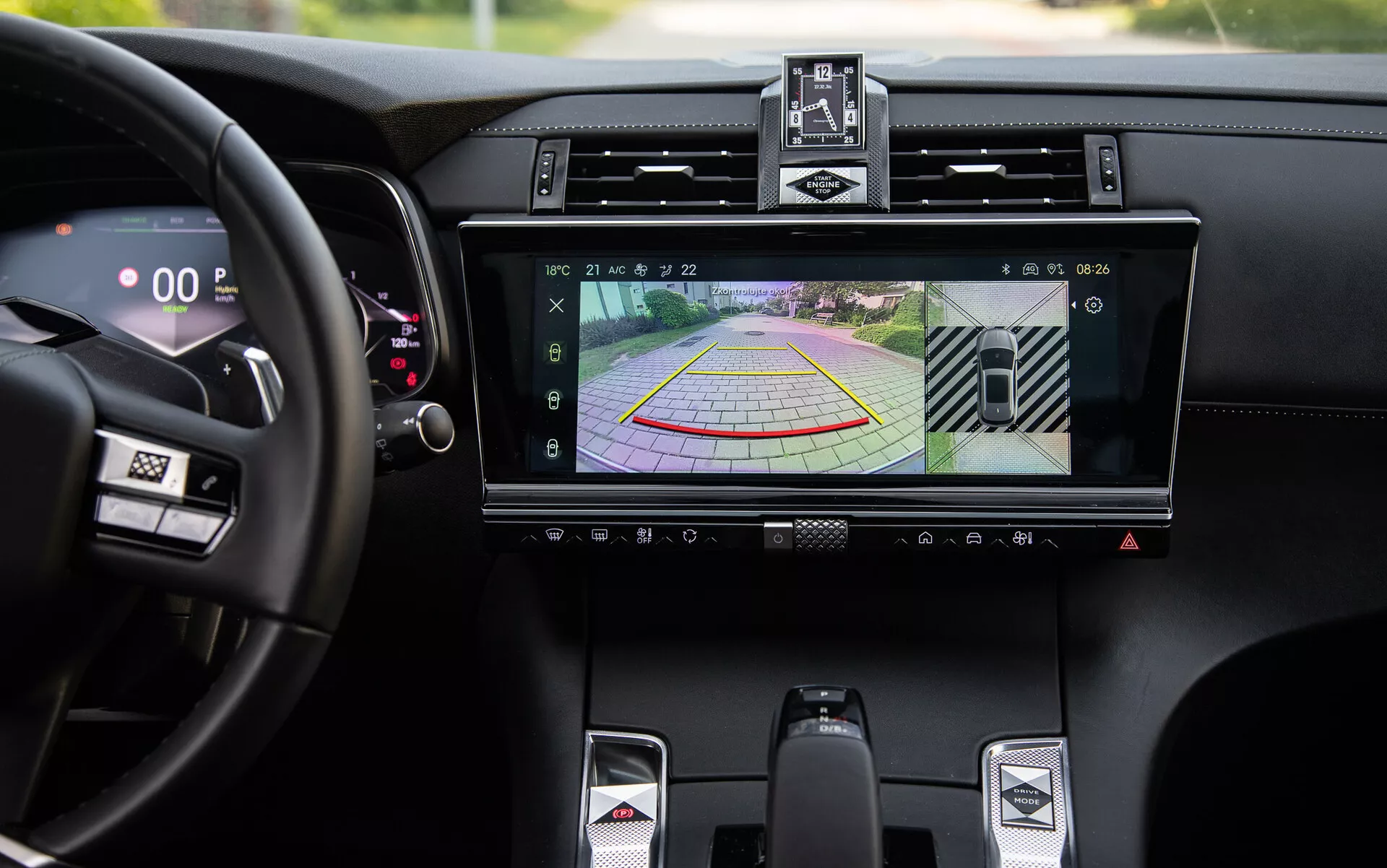 2022 DS-7 luxurious interior detail showcasing infotainment system with rearview camera display and dynamic parking assist guidelines, central air vents, climate control buttons, sporty gearshift lever, and digital speedometer