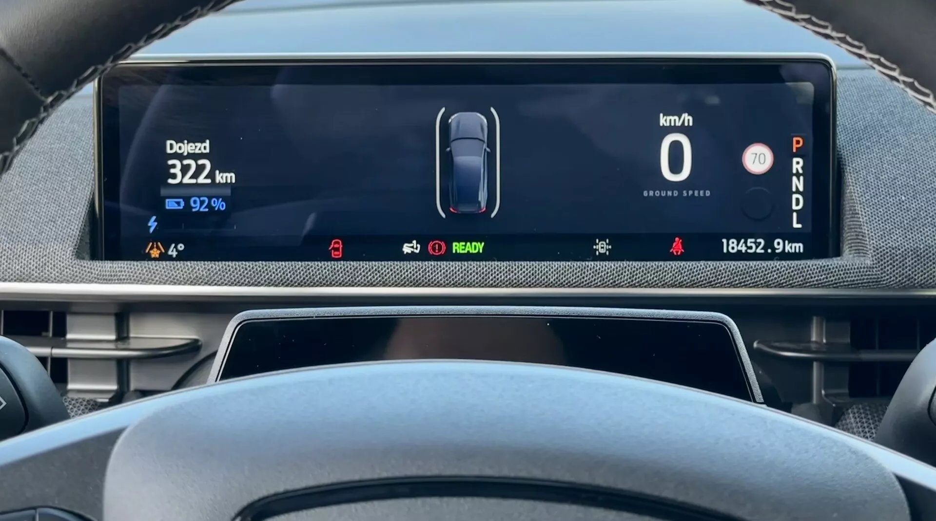 2020 Ford Mustang Mach-E digital dashboard display from driver's perspective showing vehicle speed at 0 km/h, remaining battery charge at 92%, total distance covered at 18452.9 km, and car in Park mode, with indicators for electric vehicle status and advanced driver-assistance systems