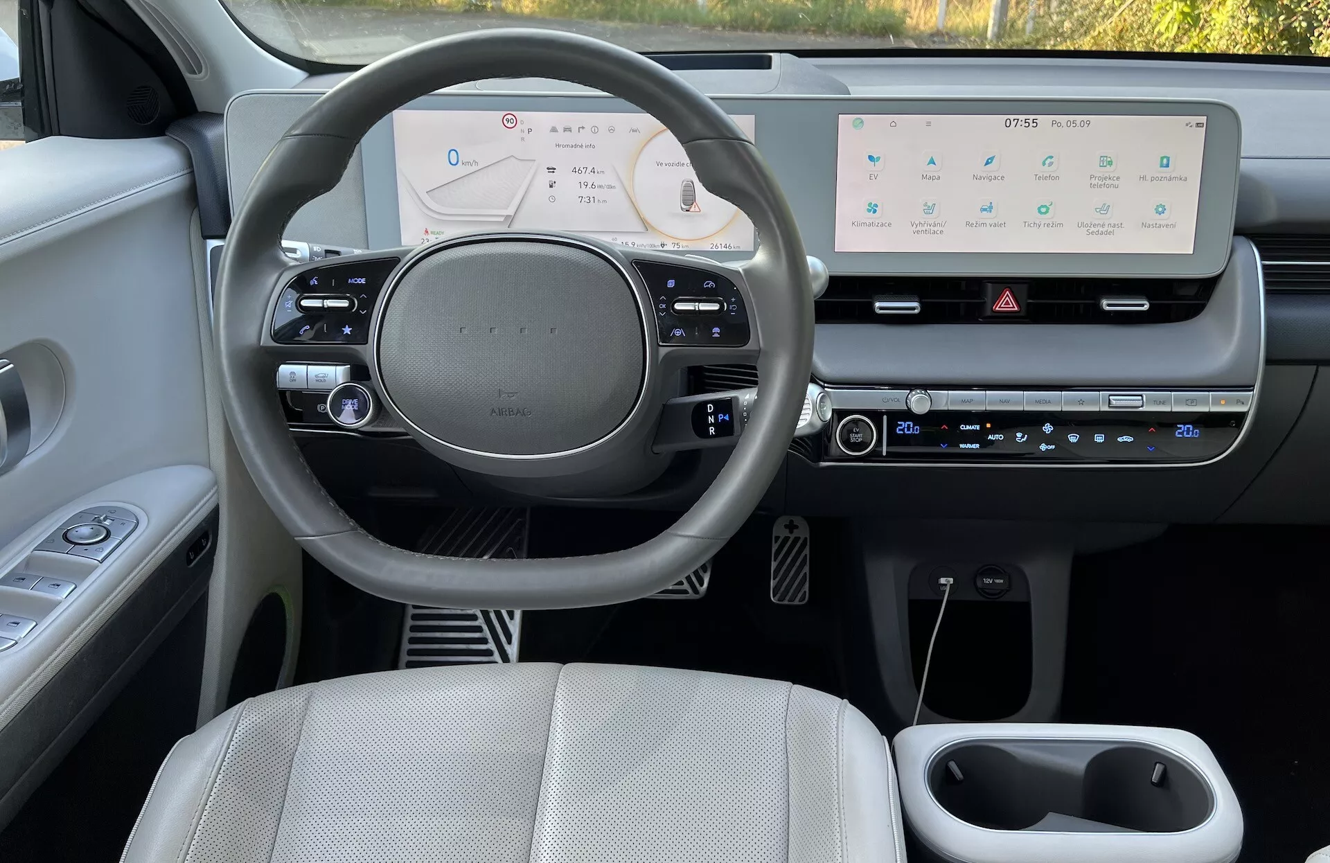 2021 Hyundai IONIQ 5 interior view showcasing the driver's side dashboard, digital instrument cluster, and central infotainment system from the rear passenger perspective