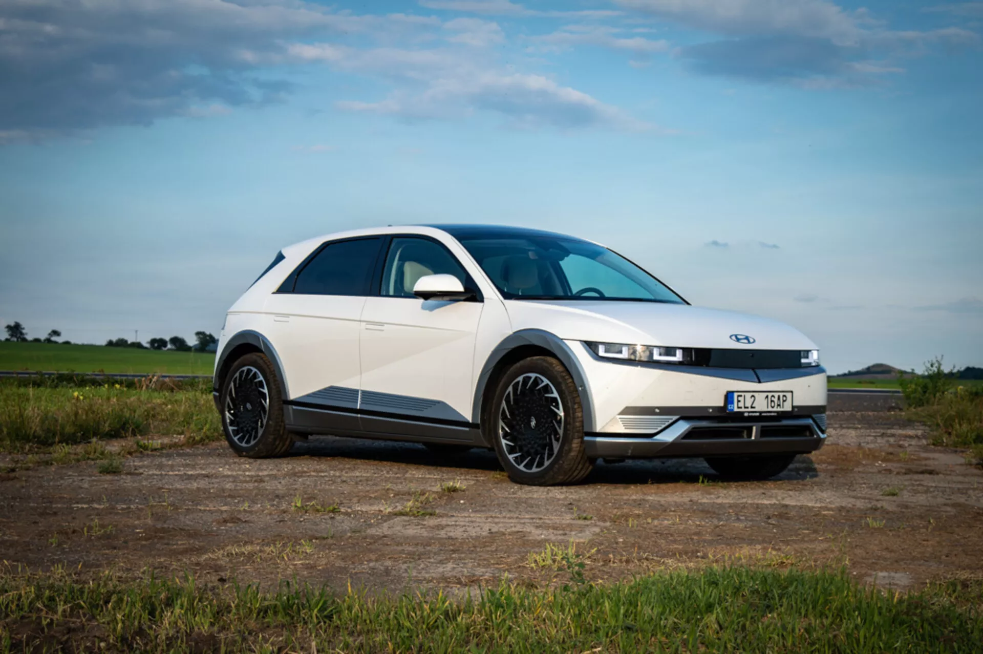 2021 Hyundai Ioniq 5 side view showcasing its sleek silver design, futuristic lines, and distinctive LED headlights