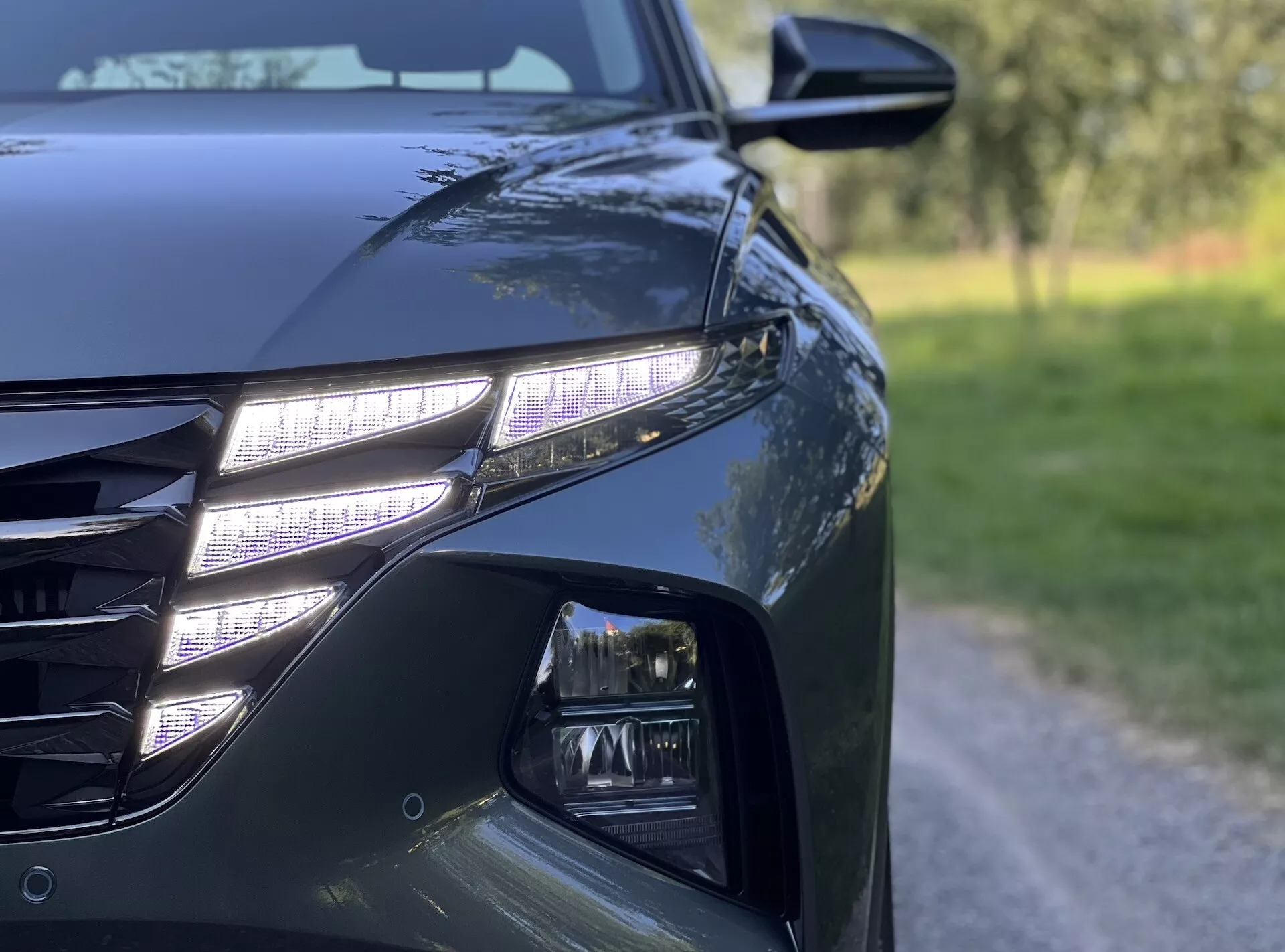 2020 Hyundai Tucson close-up view highlighting LED headlights, modern grille, and aerodynamic design details