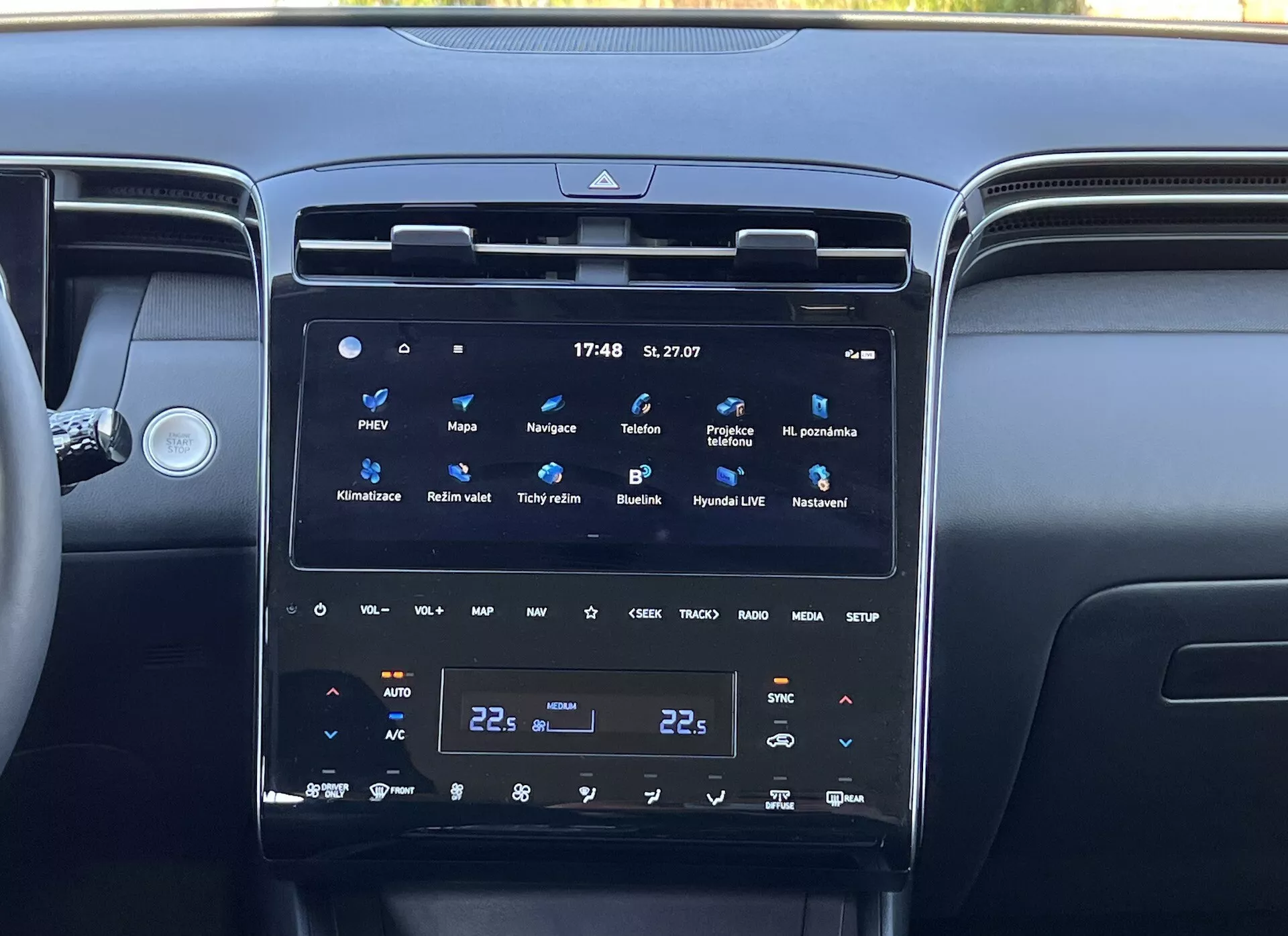 2020 Hyundai Tucson interior showing the center console with a large, vertical touch screen infotainment system, dual-zone climate control, and surround air vents, reflecting modern vehicle technology and luxury
