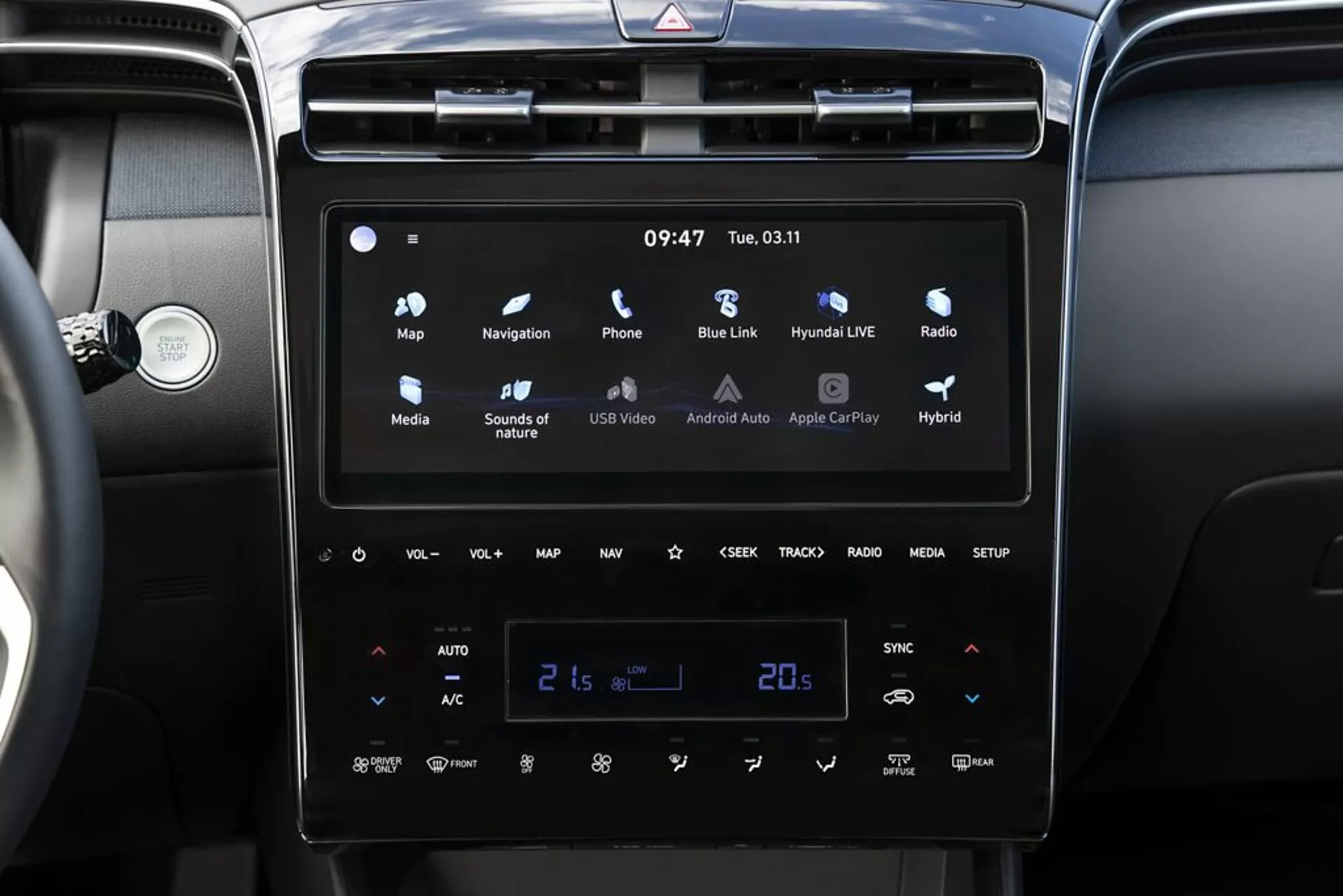 2020 Hyundai Tucson interior featuring a modern touchscreen infotainment system with Android Auto and Apple CarPlay, dual-zone automatic climate control set at 21 degrees Celsius, and hybrid vehicle indicators