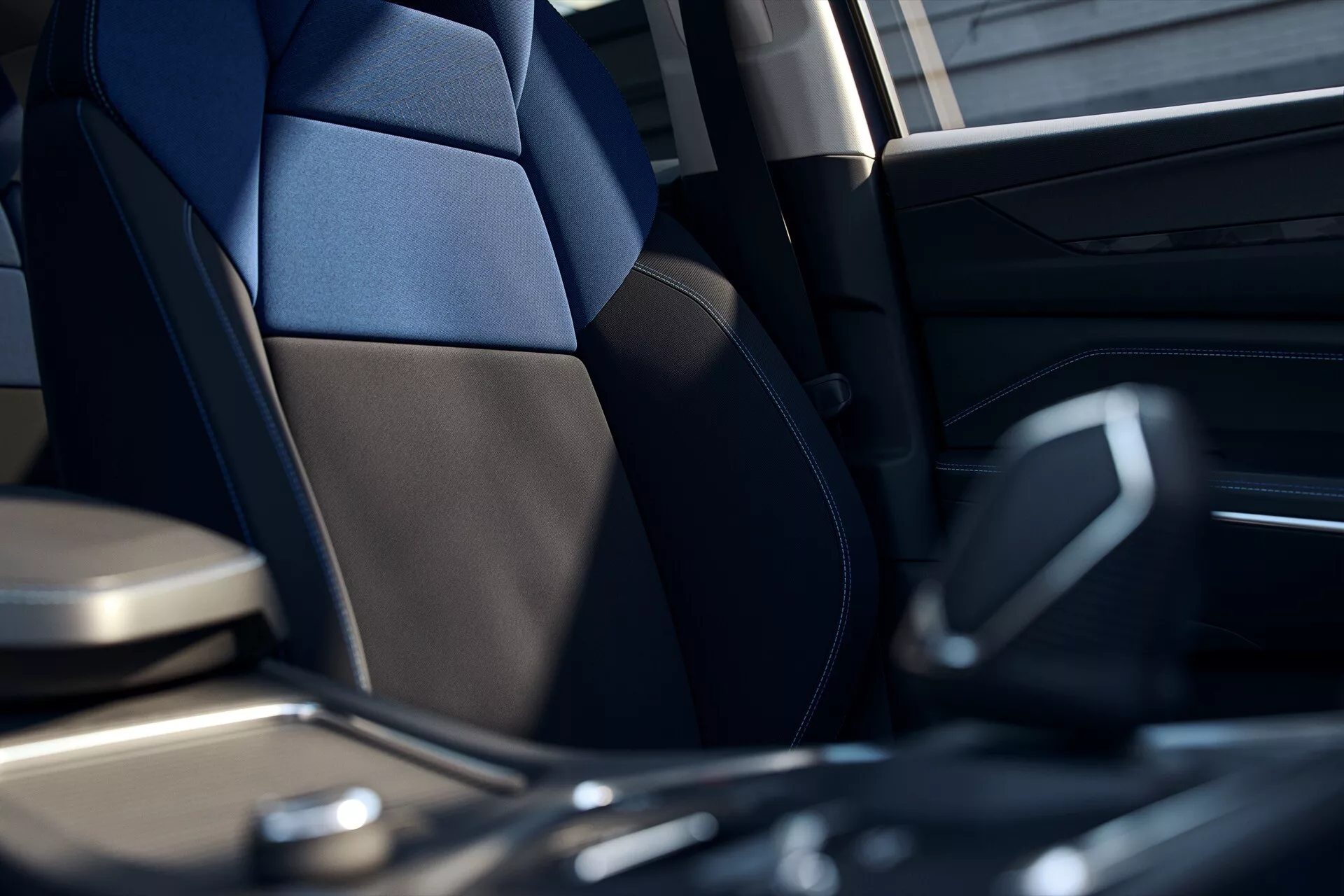 Low-angle interior view of a Lynk & Co 01 2021 highlighting the driver's seat and center console with a focus on ergonomic design and modern technology