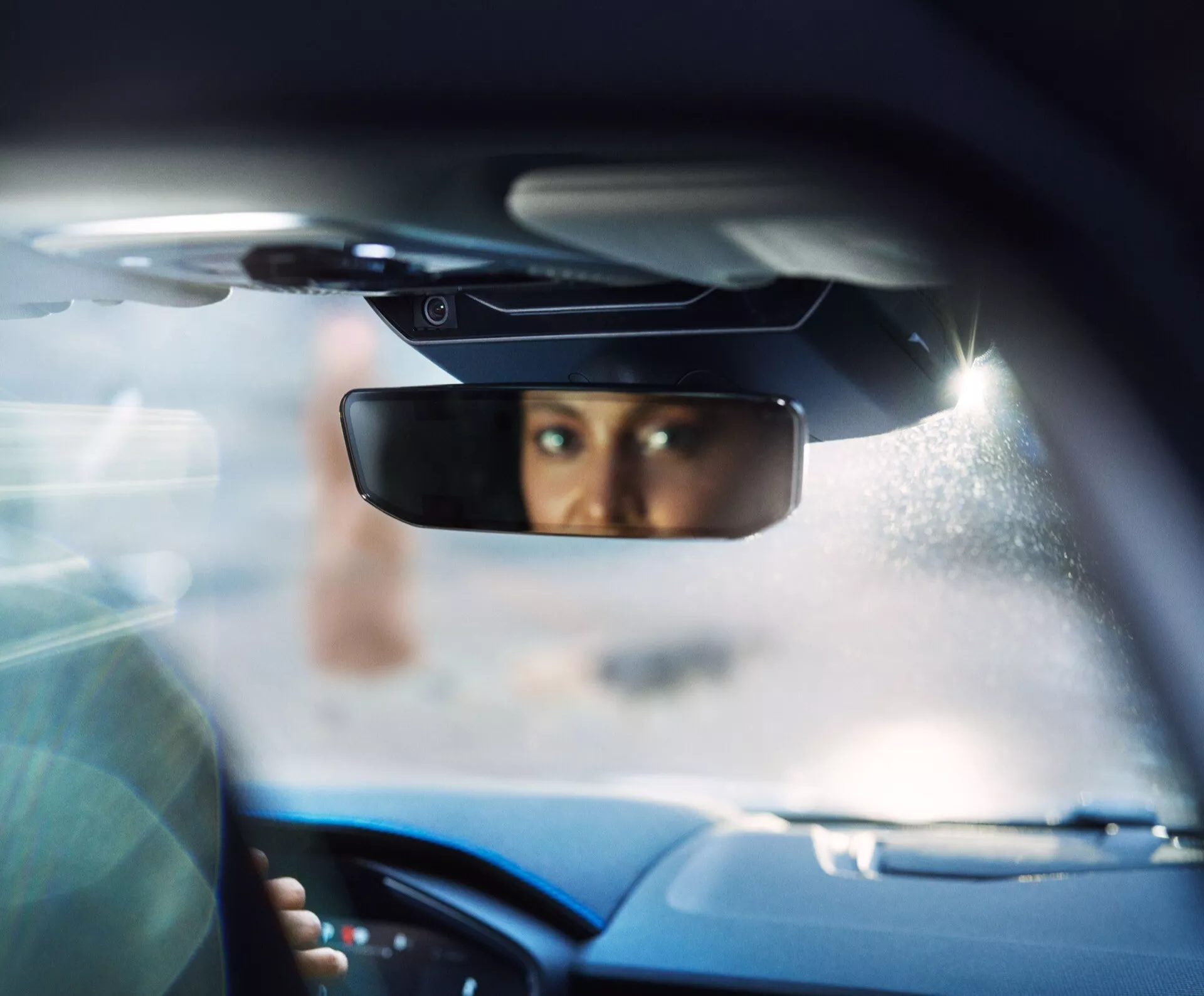 2021 Lynk & Co 01 (1st Generation) interior view focusing through the rear-view mirror from the backseat, highlighting advanced safety features and sophisticated design.
