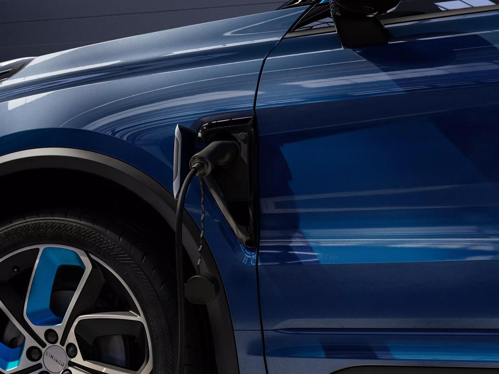 Close-up side view of Lynk & Co 01 2021 showing the charging port and a stylish alloy wheel, reflecting its electric or hybrid nature and luxury features