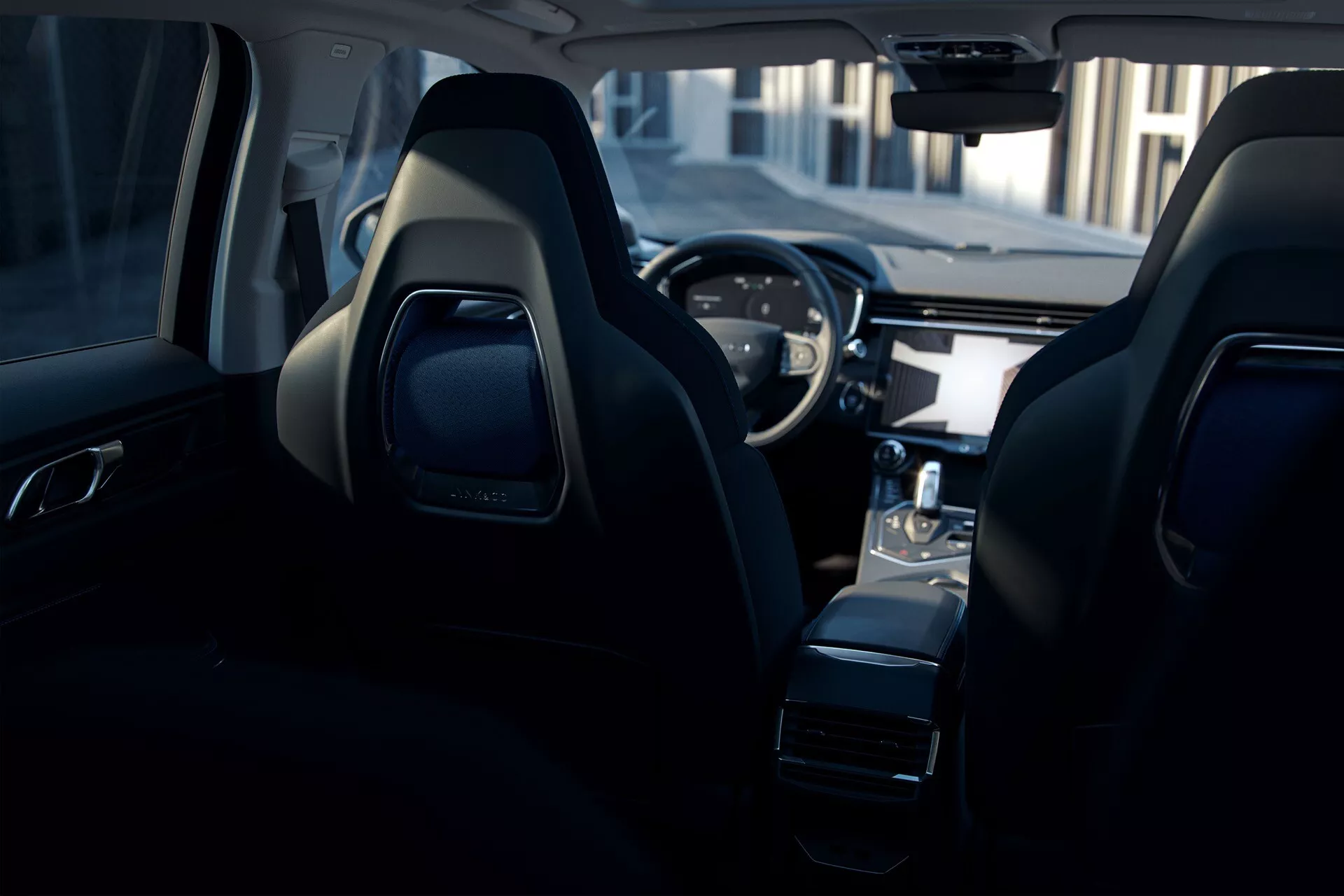 Interior view of the 2021 Lynk & Co 01, showcasing sporty front seats, sleek dashboard with digital cluster, sporty steering wheel with integrated controls, center console with electronic shifter, and advanced infotainment screen from a rear-seat perspective