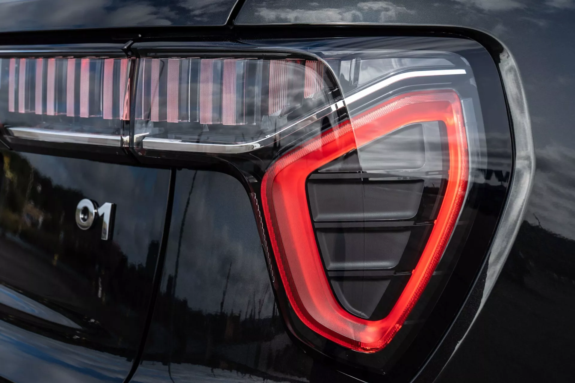 2021 Lynk & Co 01 (1st Generation) close-up detail showcasing the modern C-shaped LED taillight technology with '01' marking