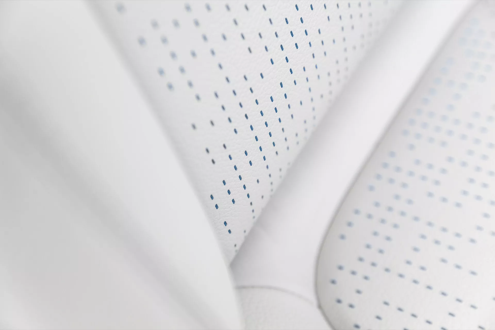 Detailed view of the Mercedes-Benz EQA 2021's white leather interior focusing on the ventilated seat's texture and craftsmanship