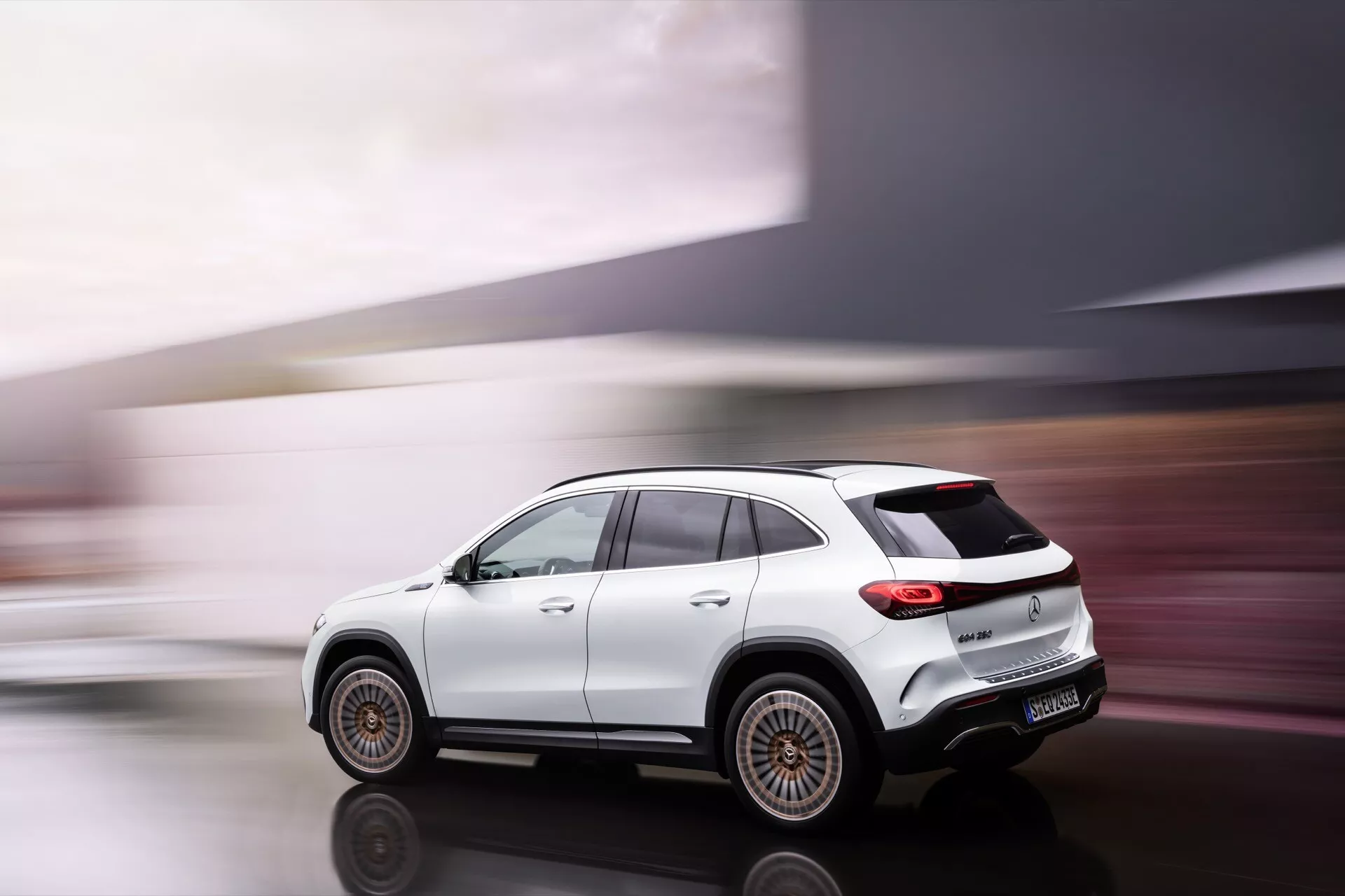 2021 Mercedes-Benz EQA luxury compact SUV in motion, three-quarter rear view showcasing dynamic design and advanced technology features