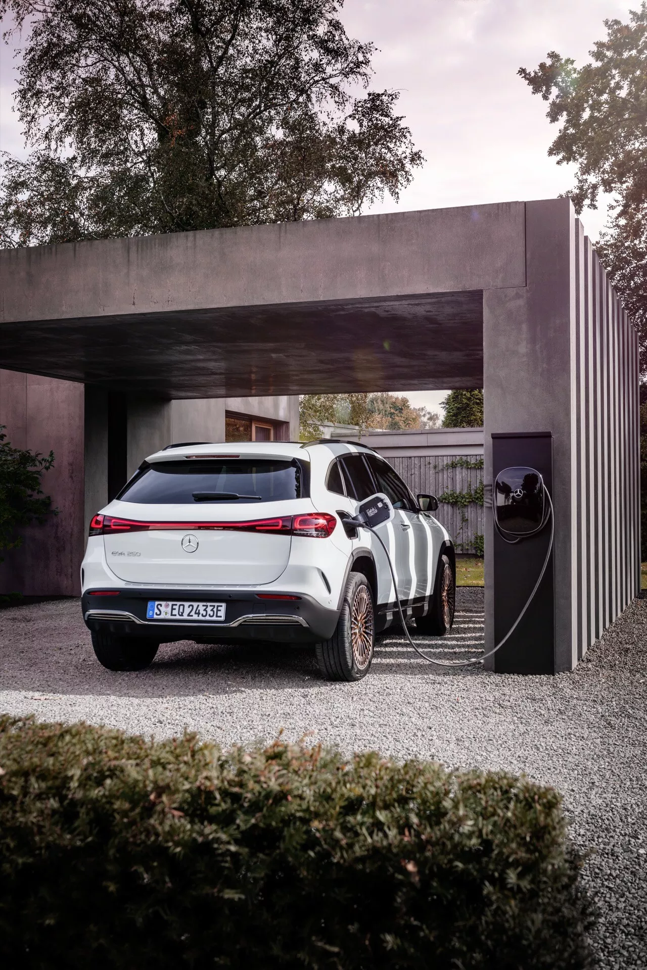 2021 Mercedes-Benz EQA electric vehicle parked at a private charging station, highlighting its sleek design and modern technology features against a contemporary architectural backdrop