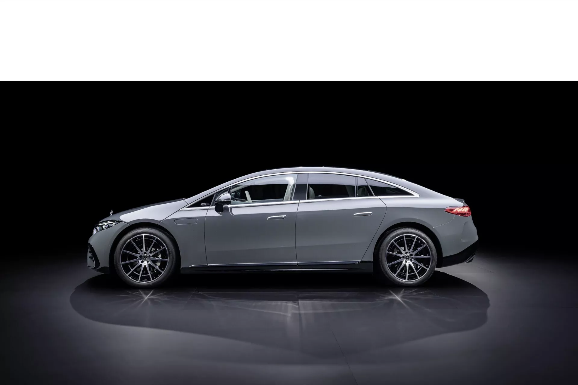 2024 Mercedes-Benz EQS Facelift profile view against dark background highlighting sleek design and body lines, with modern alloy wheels and luxury chrome accents