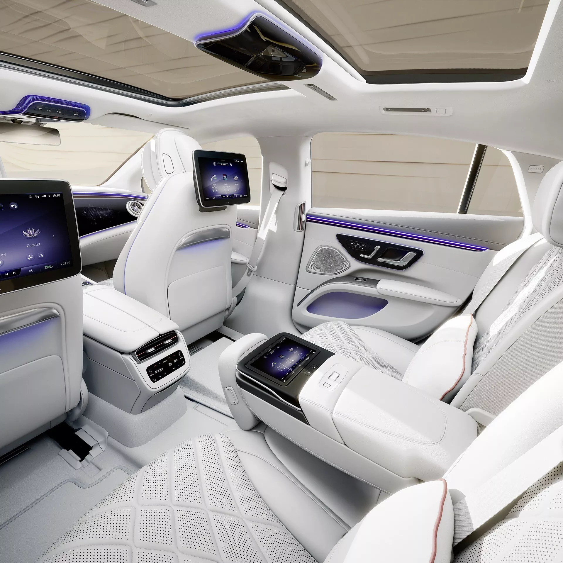 2024 Mercedes-Benz EQS Facelift interior showcasing luxury rear cabin from bird's-eye view, featuring individual contoured seats in quilted white leather, integrated touch screen center console, dedicated rear entertainment displays, advanced climate control, ambient lighting, panoramic sunroof, and tech-rich enhancements for exceptional passenger comfort and luxury.