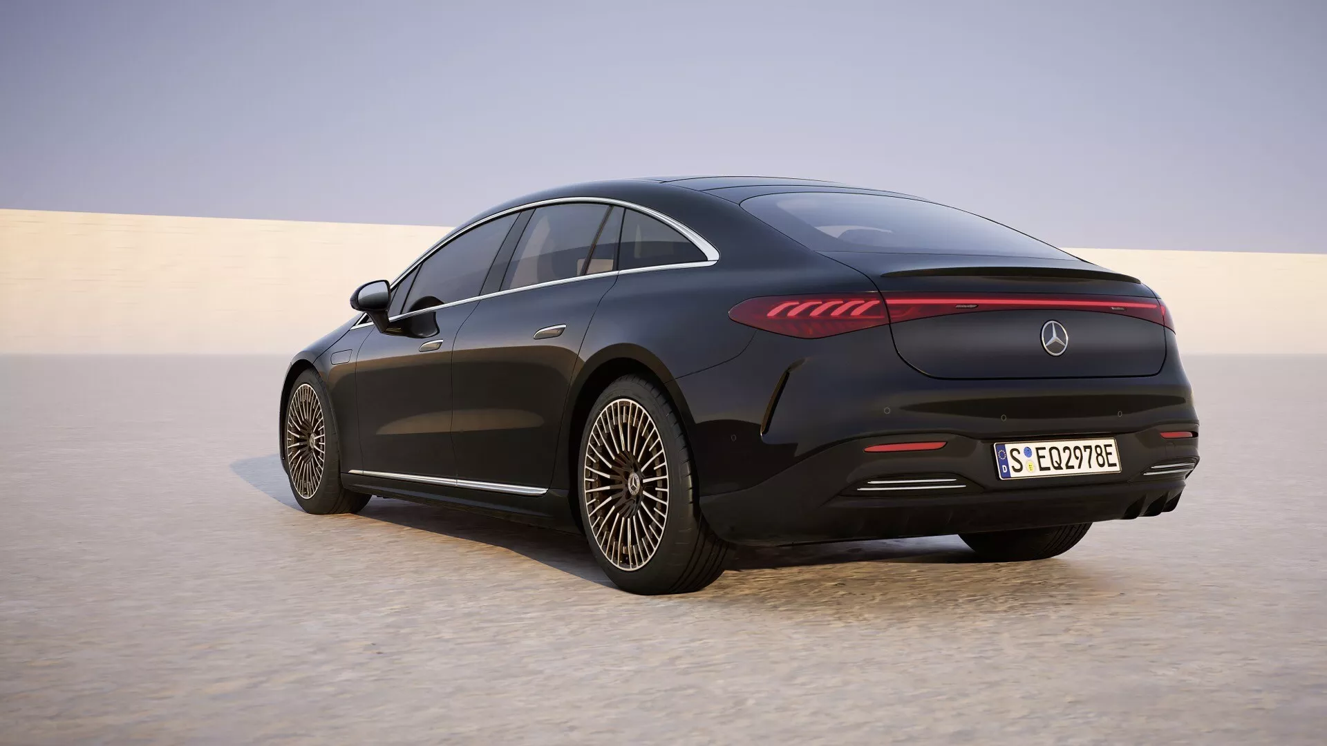 2024 Mercedes-Benz EQS (297-Facelift) Rear Three-Quarter View Displaying LED Taillights, Aerodynamic Alloy Wheels, and Coupe-like Roofline on a Sandy Plain