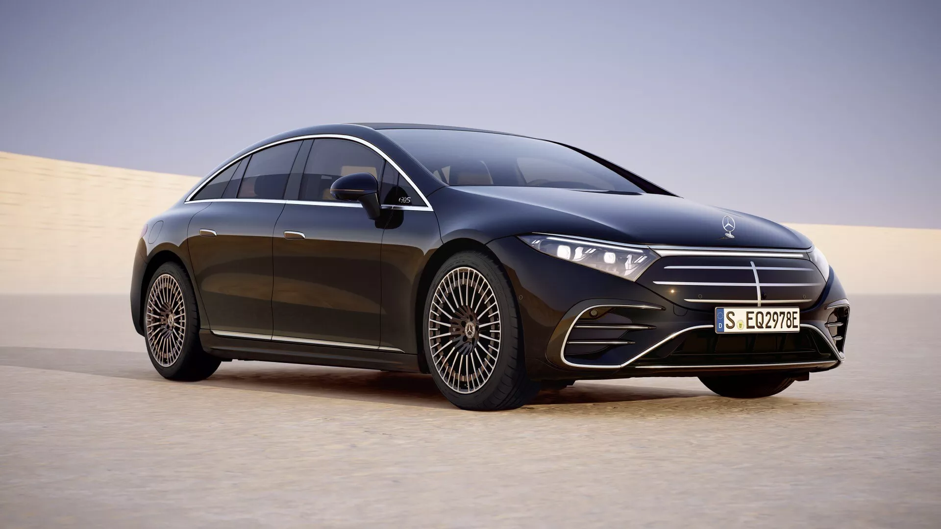 2024 Mercedes-Benz EQS luxury sedan in a three-quarter front angle showcasing its LED headlights, large front grille, multi-spoke alloy wheel, and sleek design against a desert backdrop