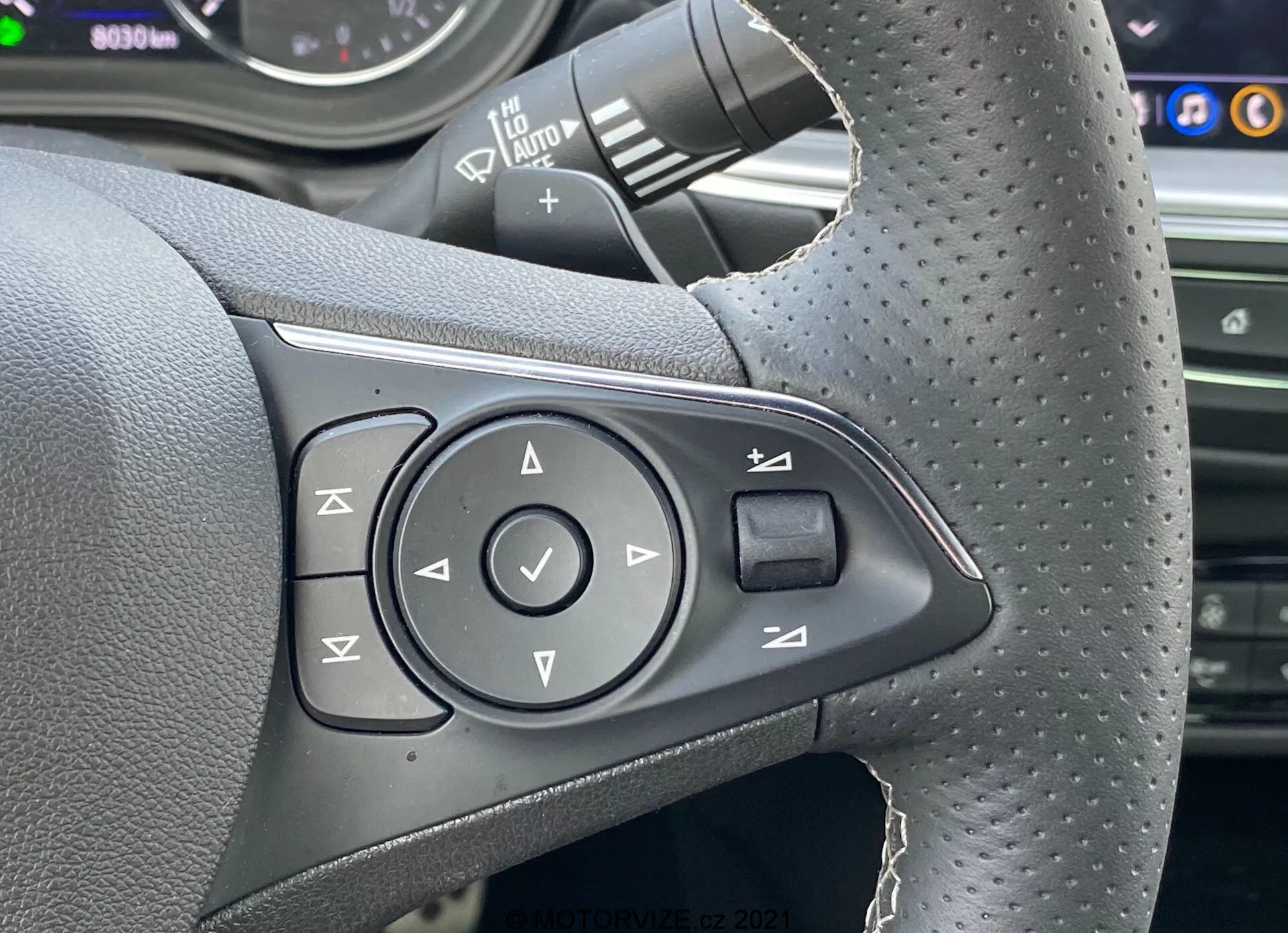 Side view of a 2020 Opel Insignia GSi Grand Sport in motion, showcasing its sleek aerodynamic design, sophisticated LED headlights, and sporty alloy wheels