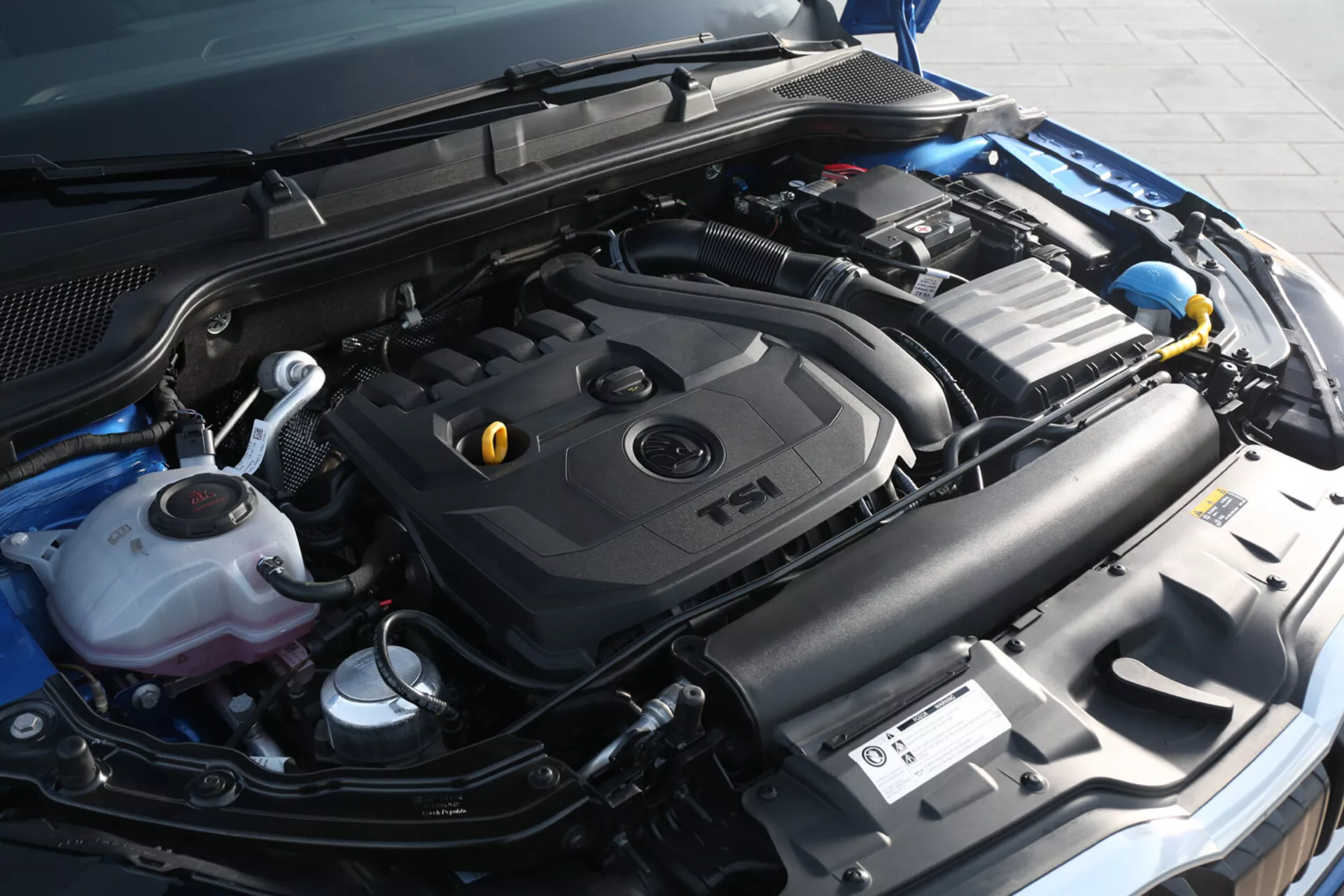 Close-up view of Skoda Scala 2019 engine bay with TSI engine cover and various components, showcasing technology and maintenance details