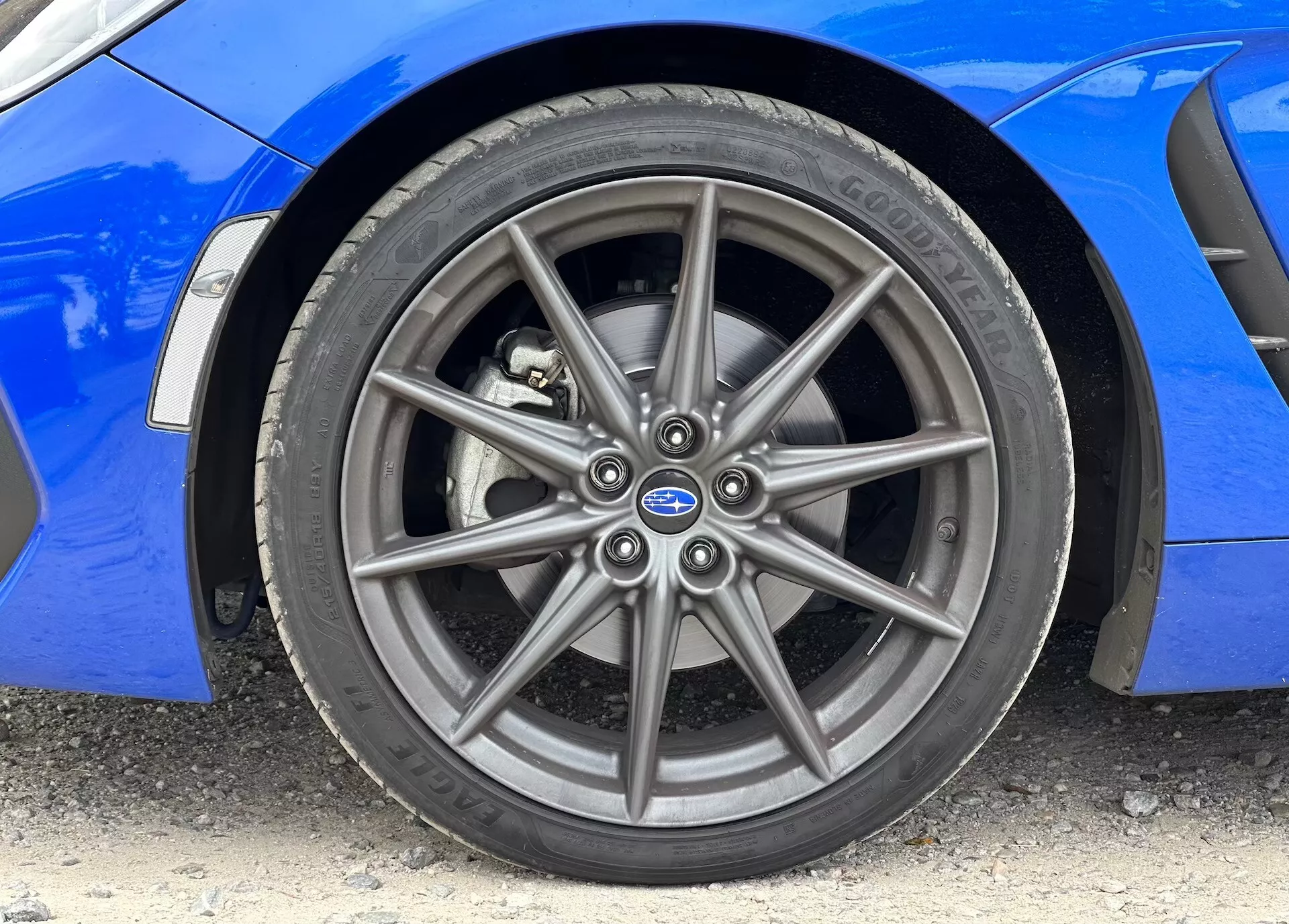 2023 Subaru BRZ close-up image showcasing the front alloy wheel and Continental tire, with vibrant blue bodywork visible