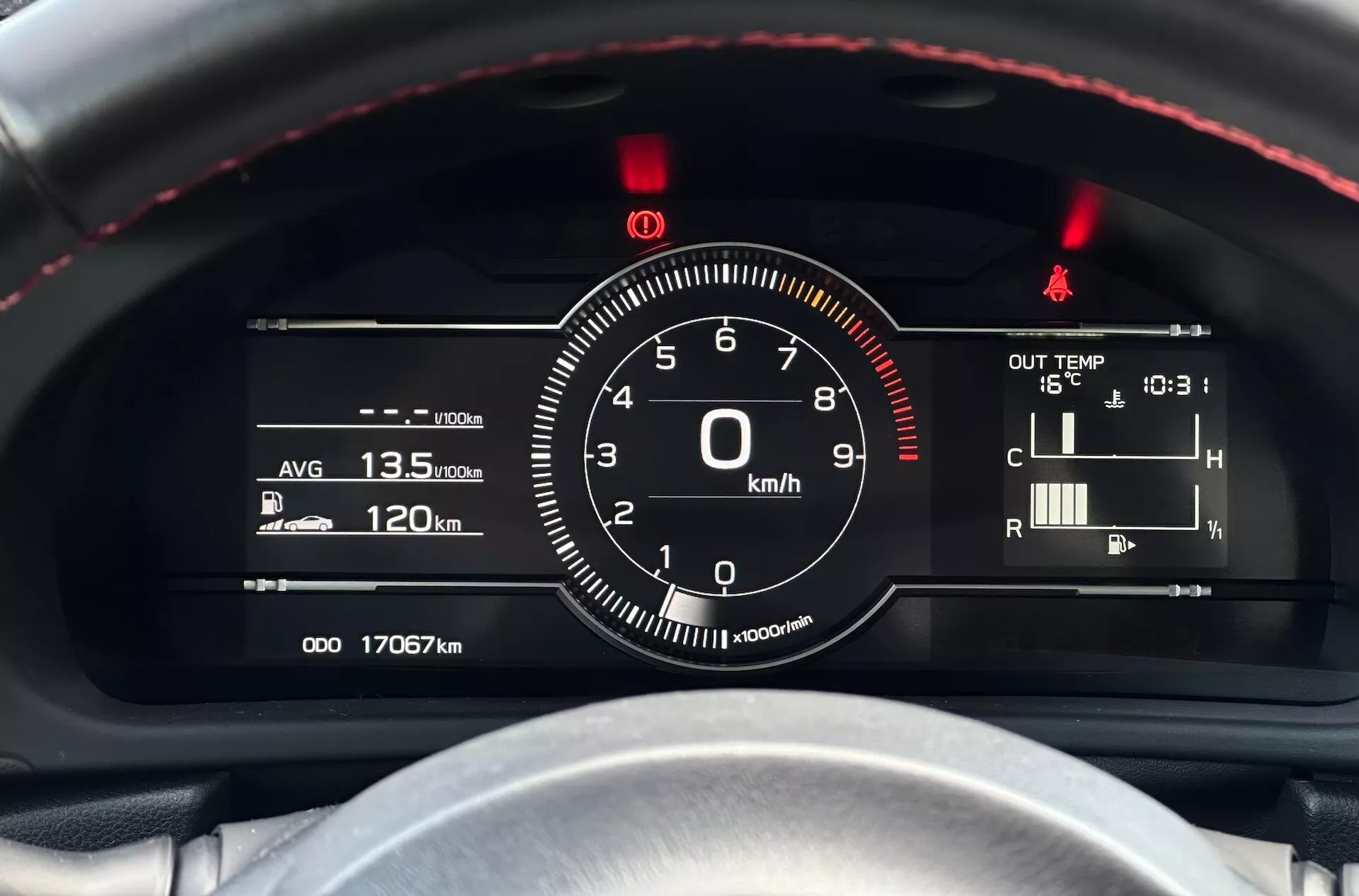 2023 Subaru BRZ detailed view of instrument cluster with a focus on the speedometer and other gauges from the driver's perspective, featuring red-stitched steering wheel, digital-analog gauge combination, and technology indicators such as fuel efficiency, temperature, and odometer readings.