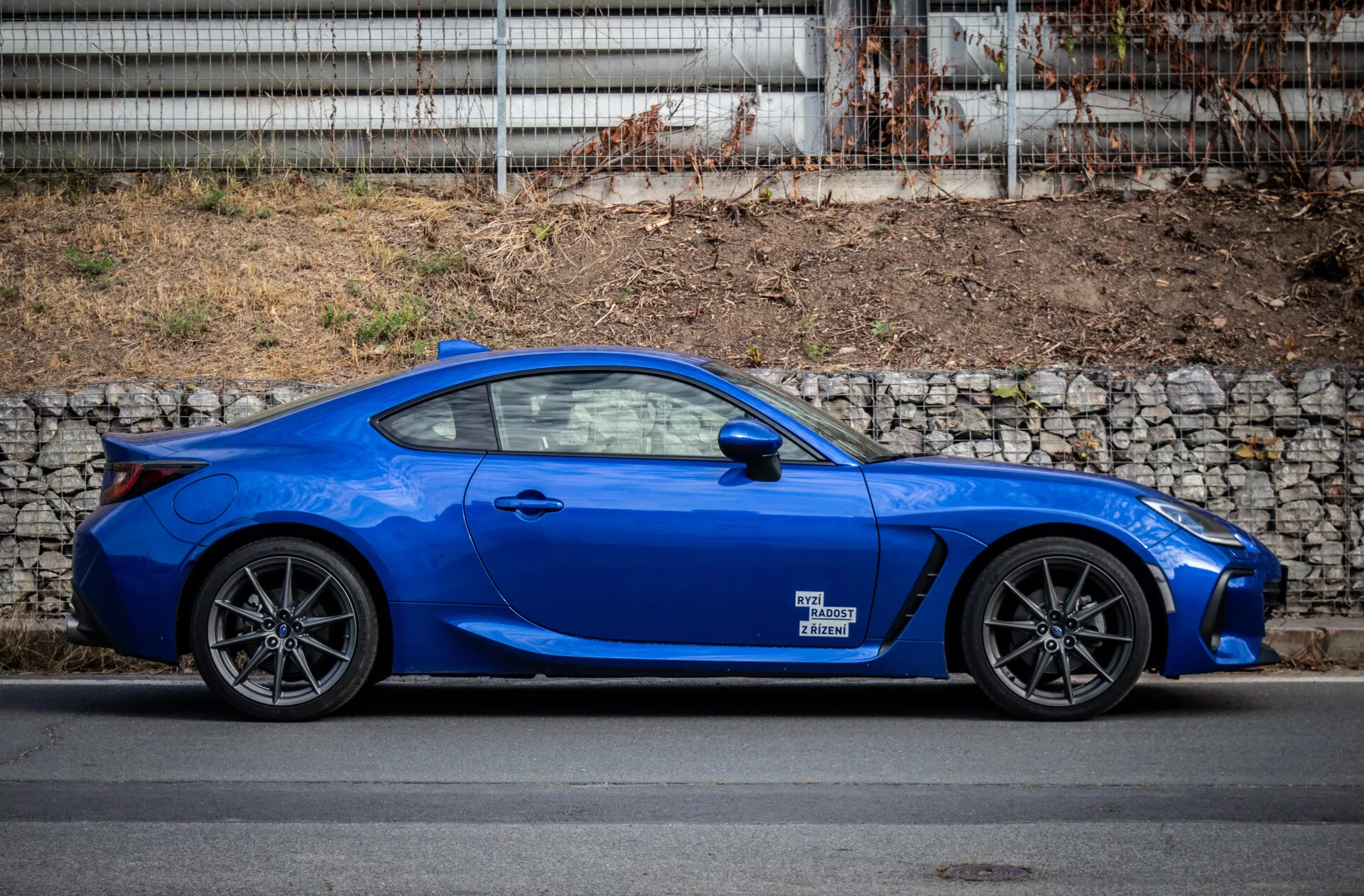 2023 Subaru BRZ parked in urban setting showcasing its sleek design and vibrant blue color