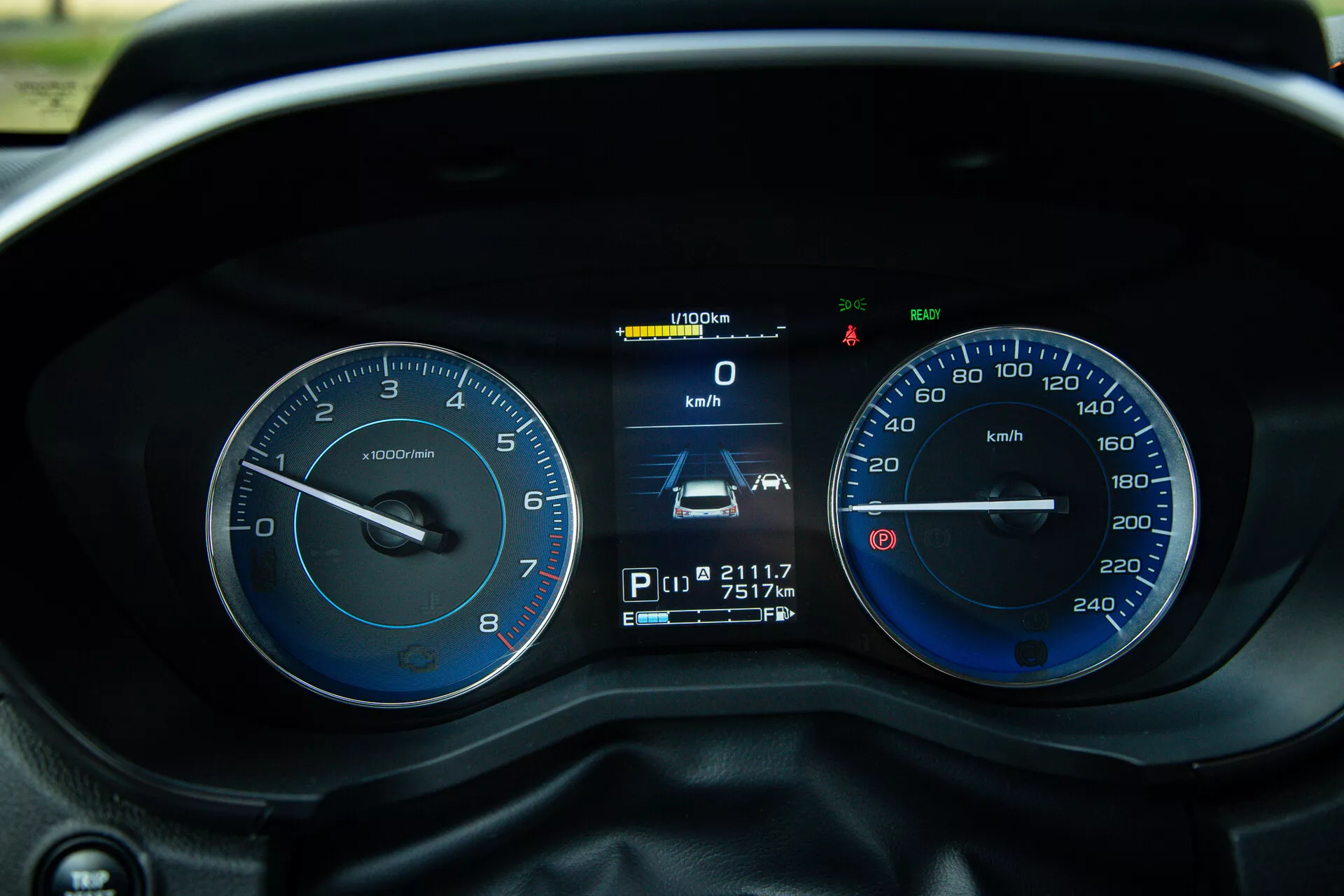 Close-up view of the Subaru XV 2021 instrument cluster with detailed driver's eye perspective of tachometer, speedometer, and digital display showing speed, gear position, odometer and trip meter readings, alongside various indicators and warning lights