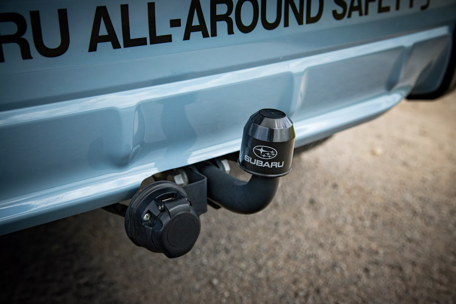 Close-up view of Subaru XV 2021 rear hitch area with embossed SUBARU logo on hitch cover, highlighting safety and adventure features