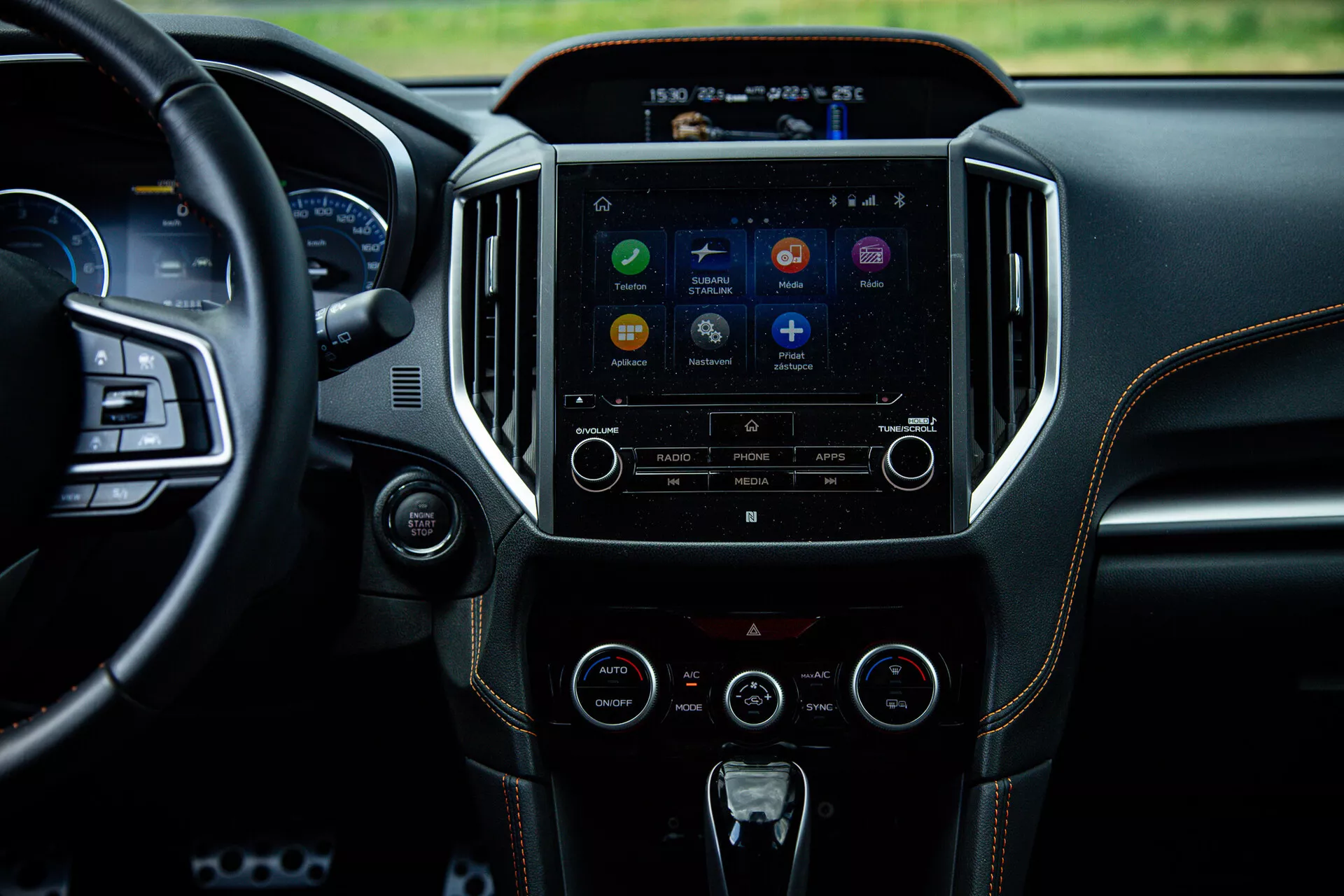 2021 Subaru XV interior highlighting the center console and infotainment system from a backseat perspective, showcasing the touch screen with app icons, audio and climate control buttons, reflecting advanced technology and luxury design