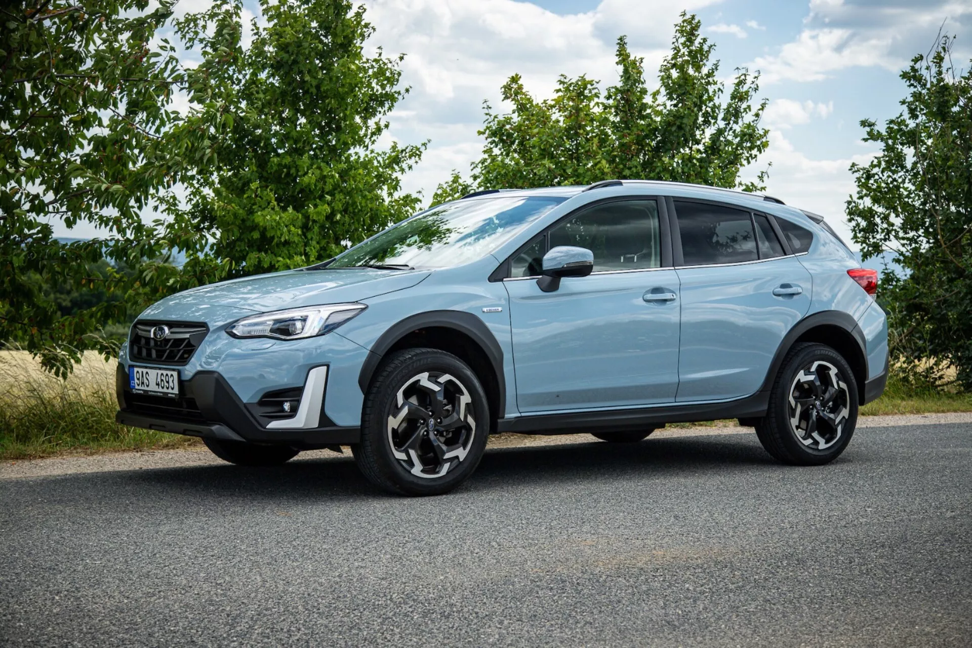 2021 Subaru XV light blue crossover SUV parked on asphalt showcasing side profile, distinctive black alloy wheels, LED taillights, high ground clearance for urban and light off-road use, and modern safety features
